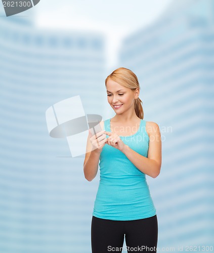 Image of sporty woman with smartphone