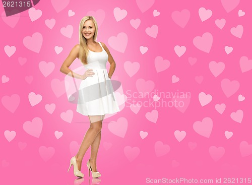 Image of woman in white dress over pink background