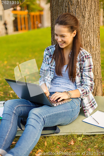 Image of smiling teenager with laptop