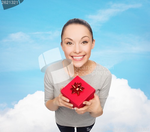 Image of smiling asian woman with red gift box