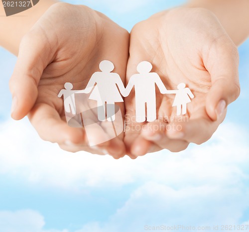 Image of female hands with paper man family