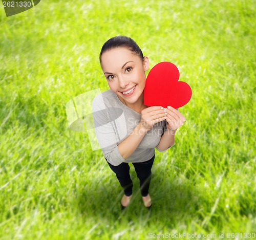 Image of smiling asian woman with red heart