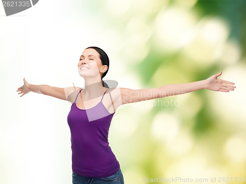 Image of smiling girl in blank purple tank top waving hands