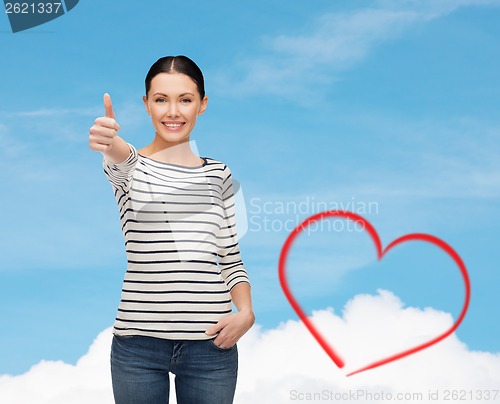 Image of smiling girl in casual clother showing thumbs up