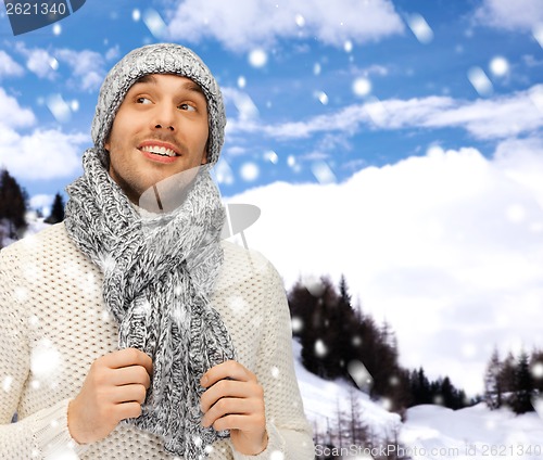 Image of handsome man in warm sweater, hat and scarf