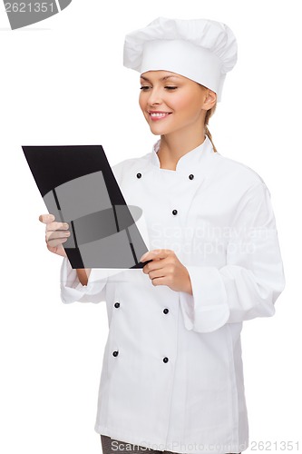 Image of smiling female chef with black blank paper