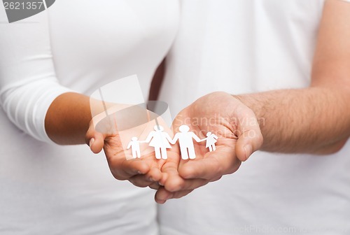 Image of couple hands with paper man family