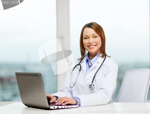 Image of busy doctor with laptop computer