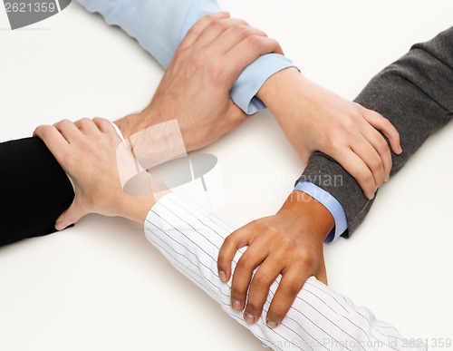 Image of closeup of businesspeople hands united