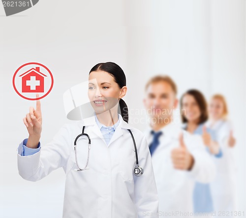 Image of smiling female doctor pointing to something