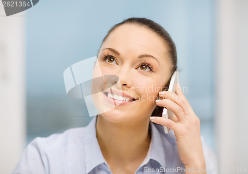 Image of african businesswoman with smartphone in office