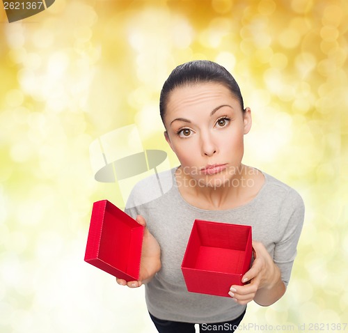Image of disappointed asian woman with empty red gift box