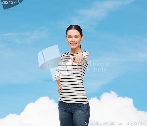 Image of smiling girl in casual clother pointing at you