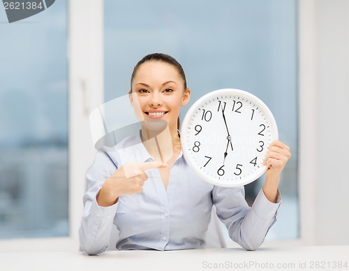 Image of attractive businesswoman with white clock