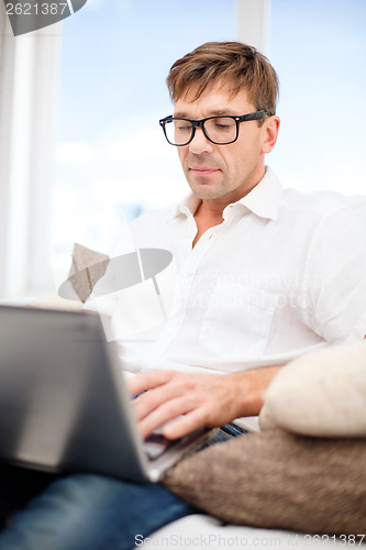 Image of man working with laptop at home