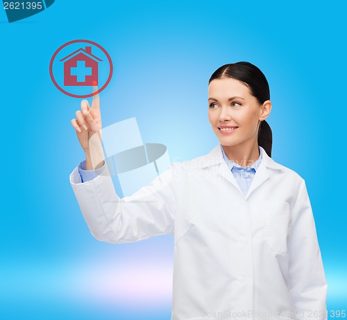 Image of smiling female doctor pointing to hospital sign