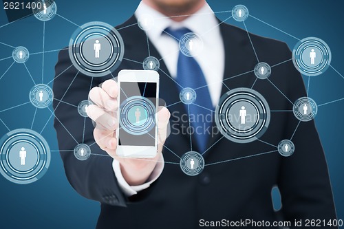 Image of businessman showing smartphone with network