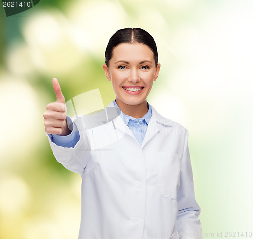 Image of smiling female doctor showing thumbs up