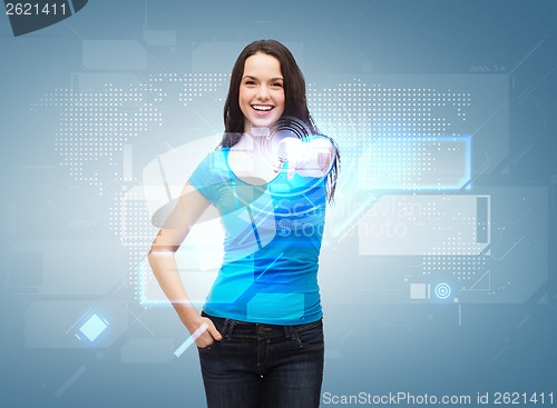 Image of happy girl in t-shirt pointing at virtual screen