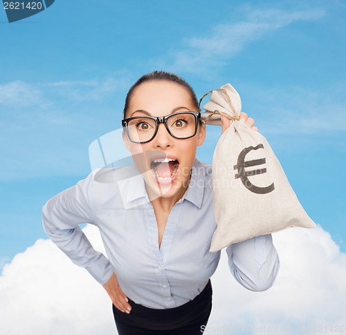 Image of amazed businesswoman holding money bag with euro