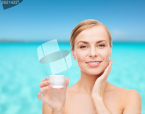 Image of woman applying cream on her skin