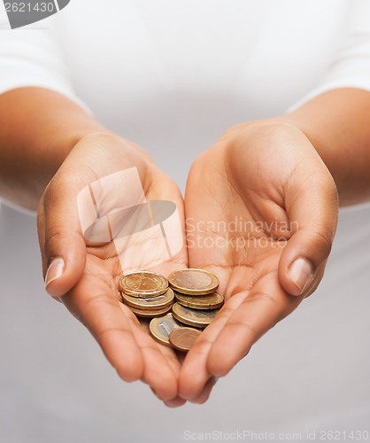 Image of womans cupped hands showing euro coins