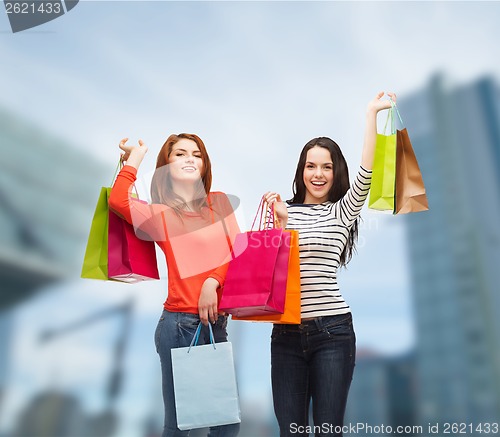 Image of two smiling teenage girls with shopping bags