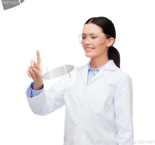 Image of smiling female doctor pointing to something