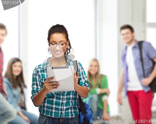 Image of student in eyeglasses with tablet pc and bag