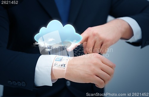 Image of businessman pointing to something at his hand