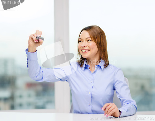 Image of businesswoman writing something in the air