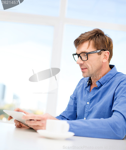 Image of man working with tablet pc at home