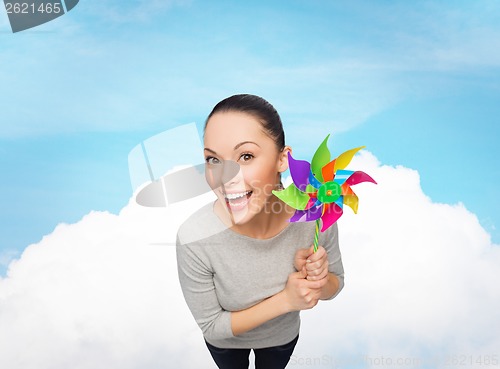 Image of smiling asian woman with windmill