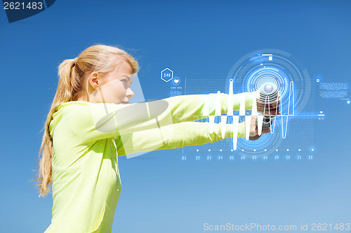 Image of sporty woman with light dumbbells outdoors