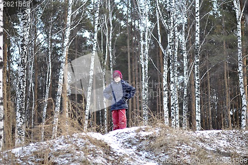 Image of Portrait of the teenage boy in the snow-covered wood.