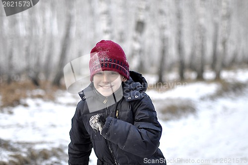 Image of Portrait of the teenage boy in the snow-covered wood.