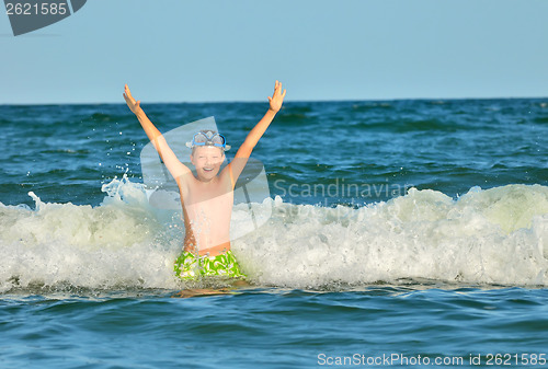 Image of Young boy enjoying the sea