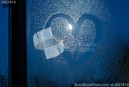 Image of Moonlight through the window. Sweaty glass and heart