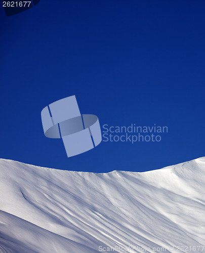 Image of Off-piste slope and blue clear sky in nice winter day