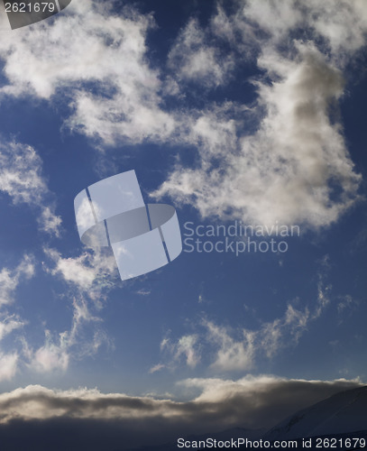 Image of Blue sky with clouds and mountains at evening