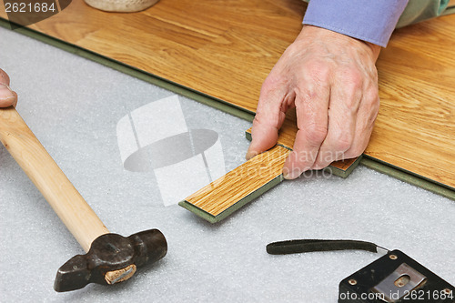 Image of Master works on laying laminate panels