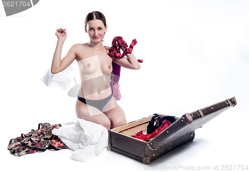 Image of Topless girl with open suitcase