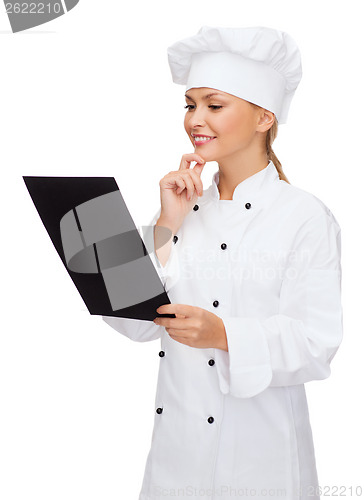 Image of smiling female chef with black blank paper