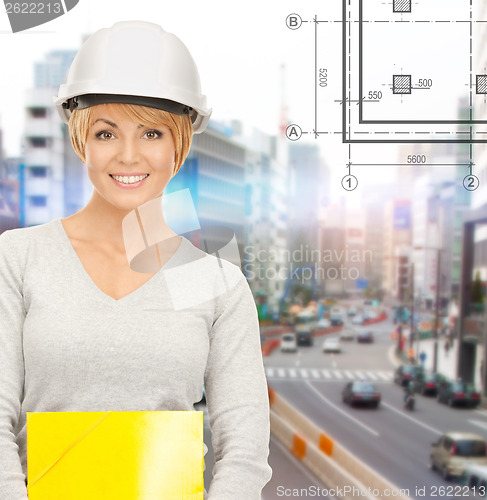 Image of female contractor in helmet with folder