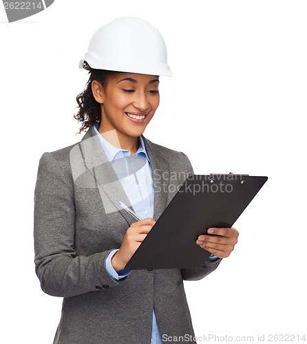 Image of businesswoman in white helmet with clipboard