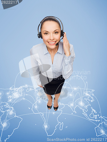 Image of friendly female helpline operator with headphones