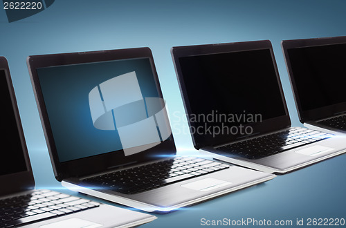 Image of many laptop computers with blank black screens