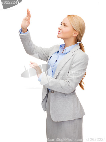 Image of smiling businesswoman pointing to something