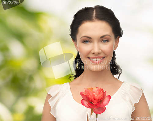 Image of young and beautiful woman with flower