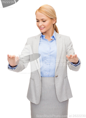 Image of smiling businesswoman pointing to something